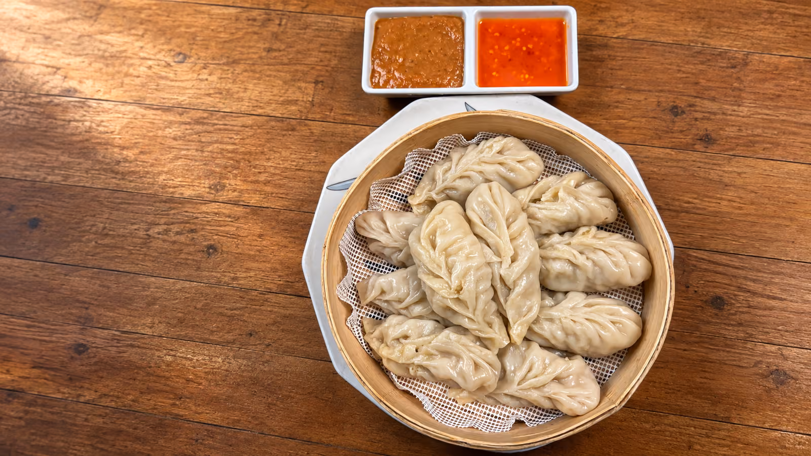 Our handmade steamed momos and dipping sauces